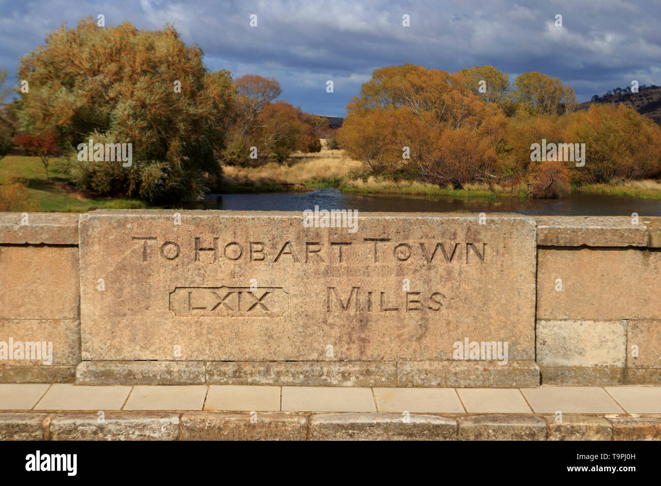 Mile Marker to Hobart on the historic convict built sandstone bridge at Ross in central Tasmania was constructed completed in 1836 to cross the Macqua Stock Photo