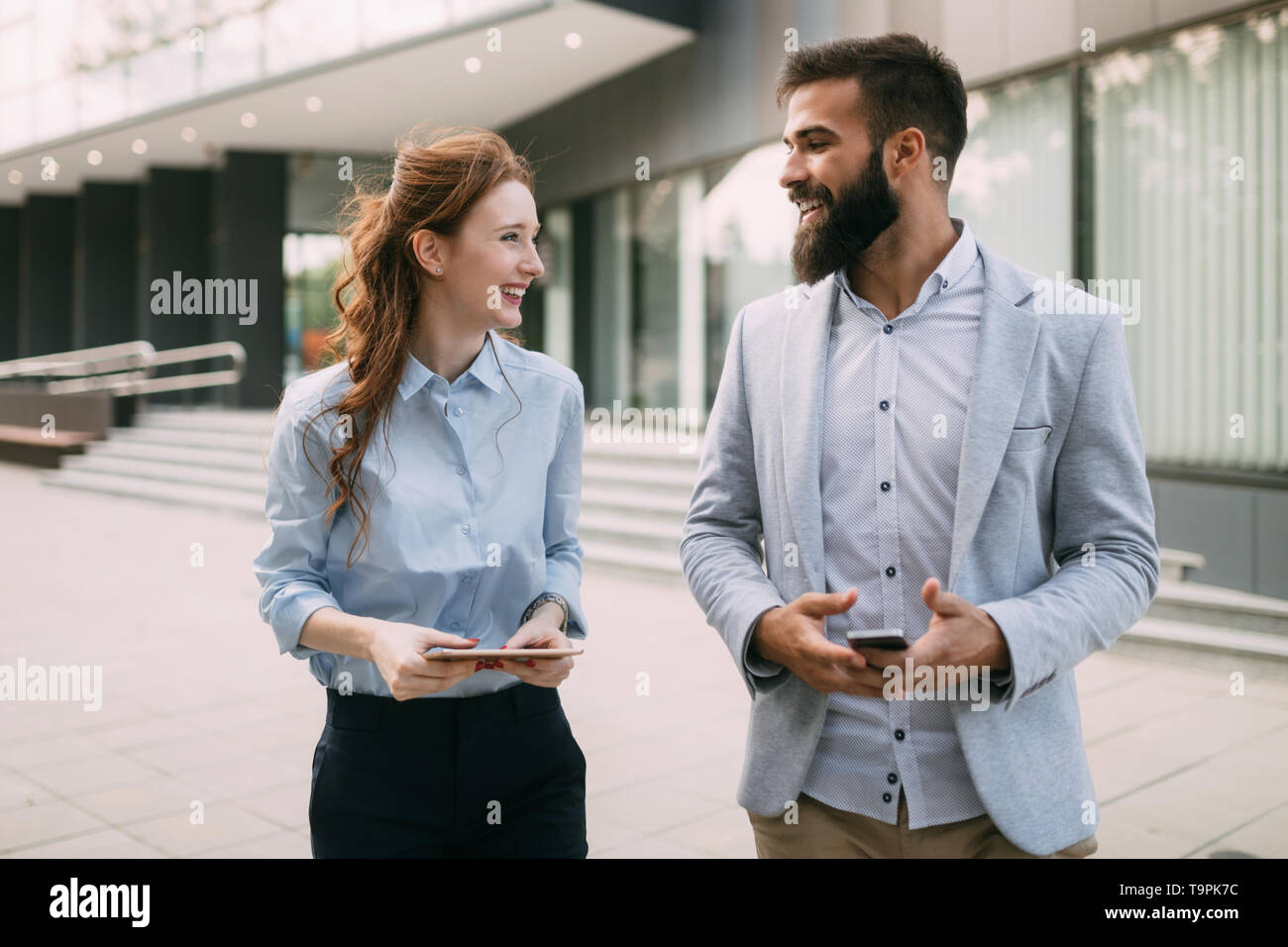 Business people walking and talking outdoor Stock Photo - Alamy