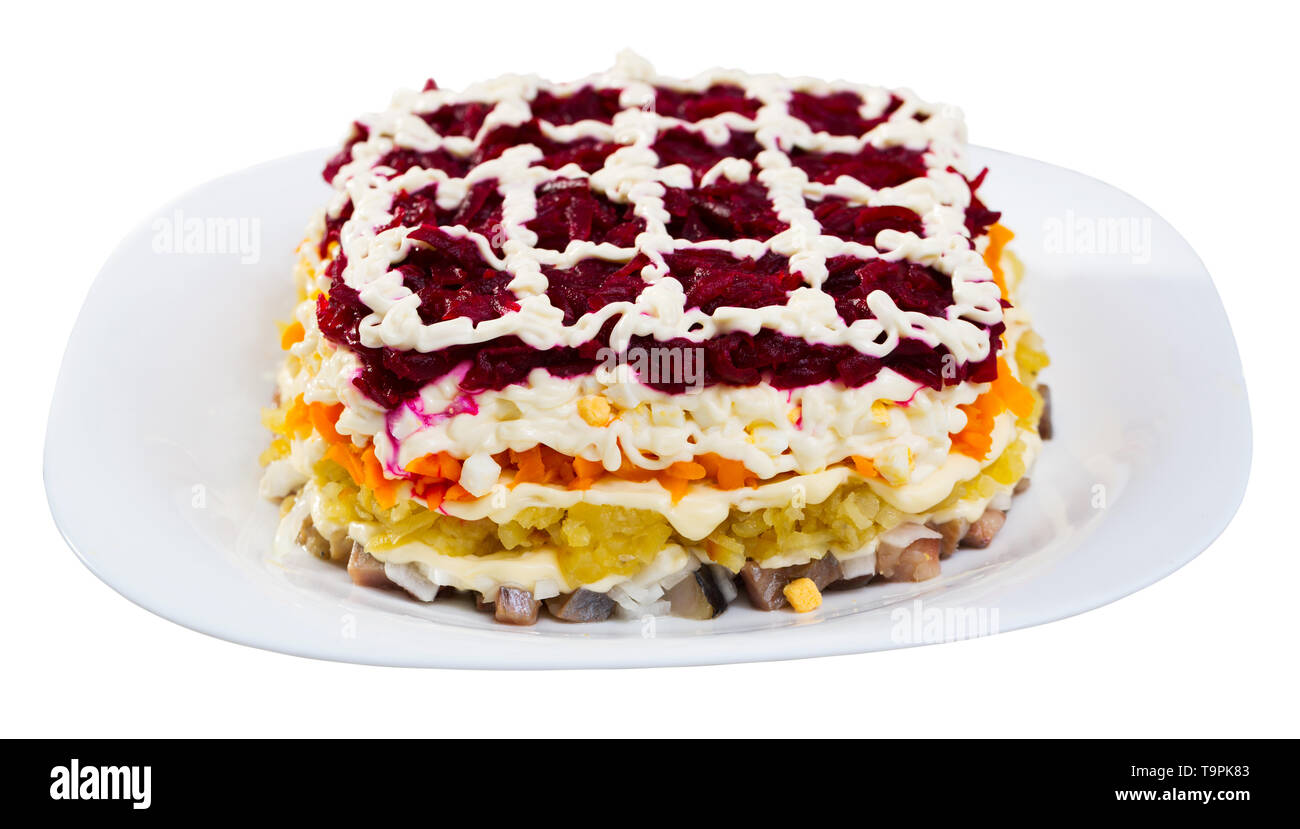 Photography of plate with Dressed herring is russian traditional dish. Isolated over white