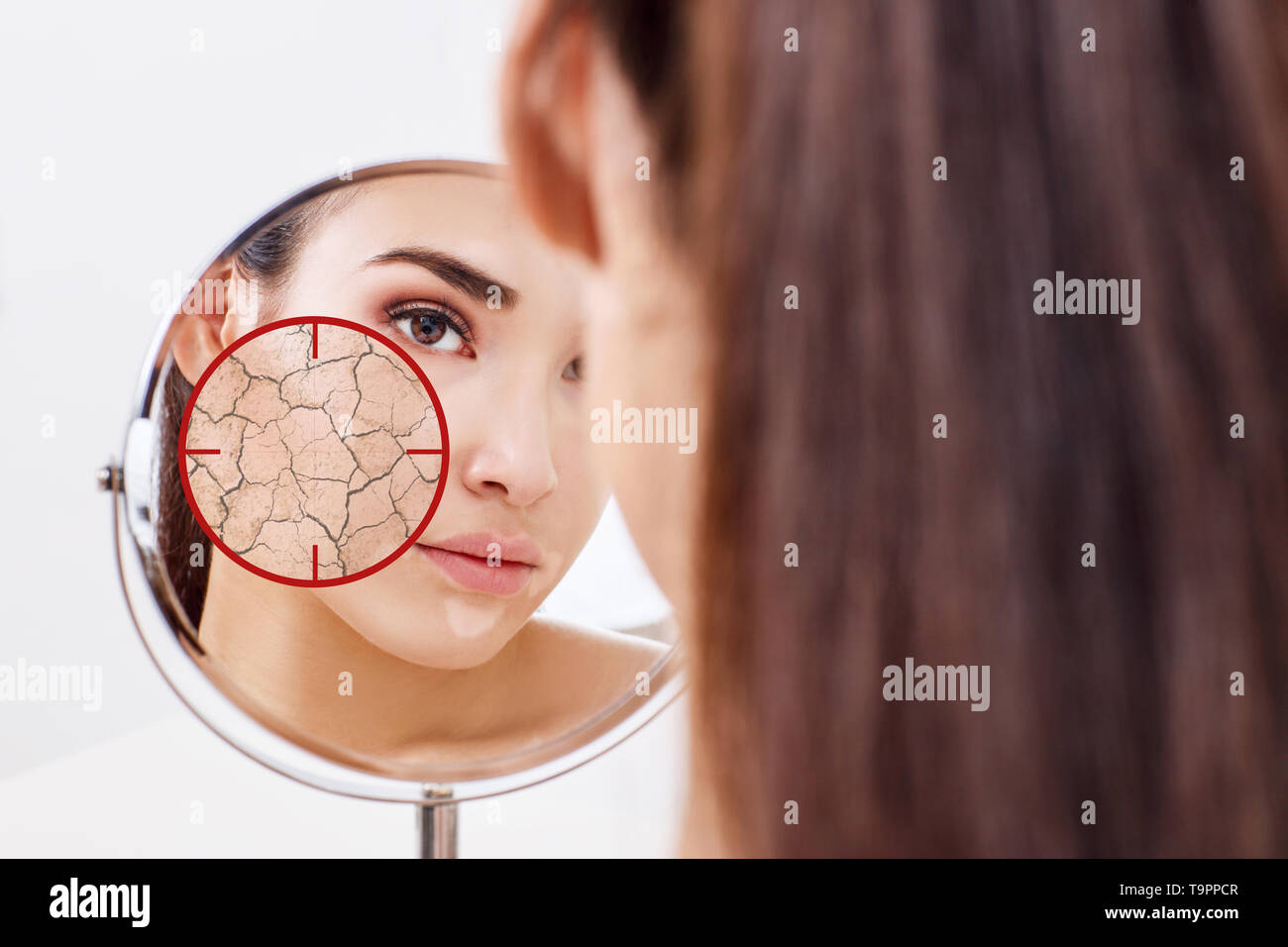 Red aim shows dry facial skin before moistening. Stock Photo