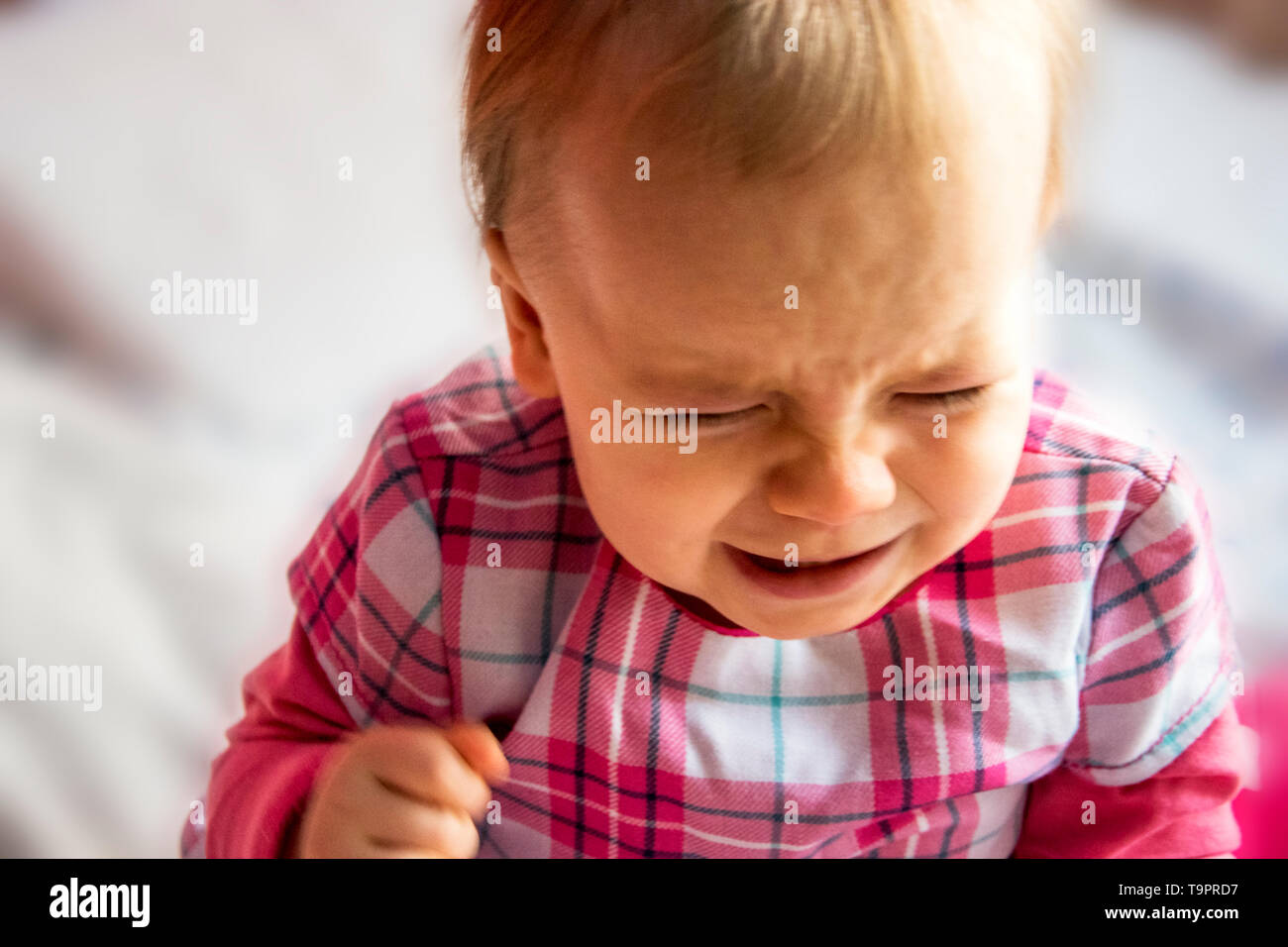 crying unhappy little child. little girl is flooding with tears Stock Photo