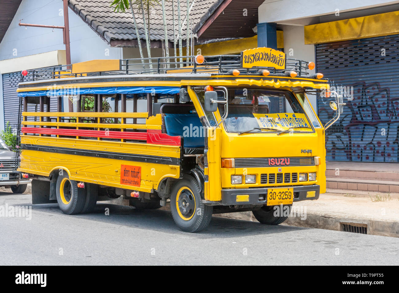 Phuket, Thailand - May 20th 2010: Yellow school bus. This is typical of bus transport on the island. Stock Photo