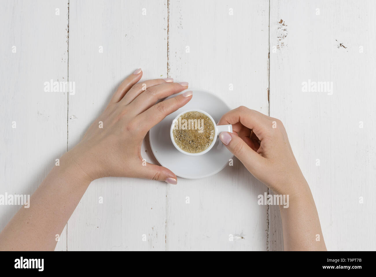 A woman's hand holding an espresso cup Stock Photo - Alamy