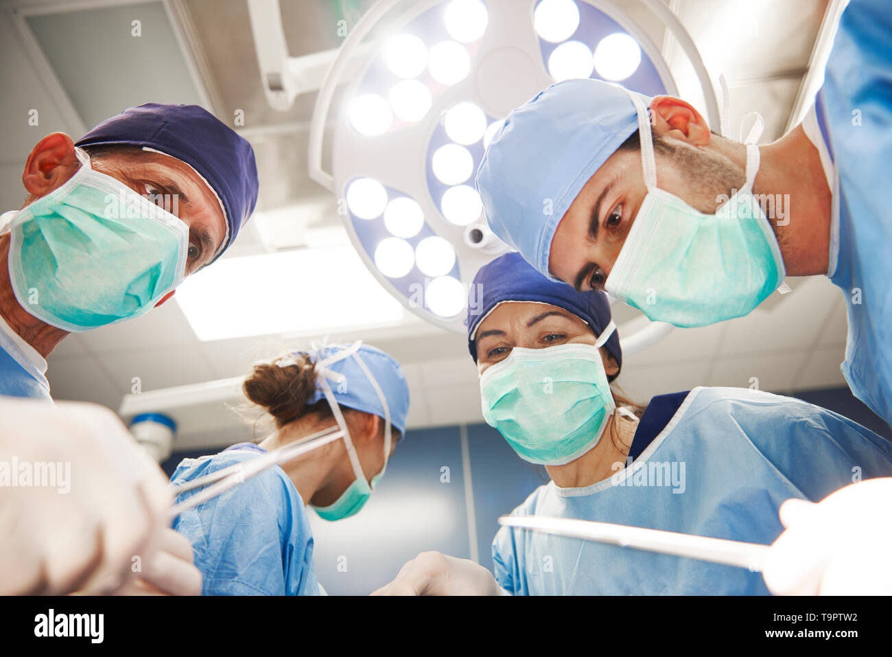 Low angle view of surgeons over the operating table Stock Photo