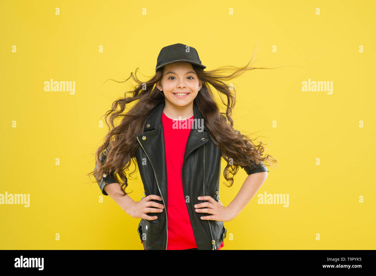 Girl adorable kid long wavy hair yellow background. Strong persistent ...