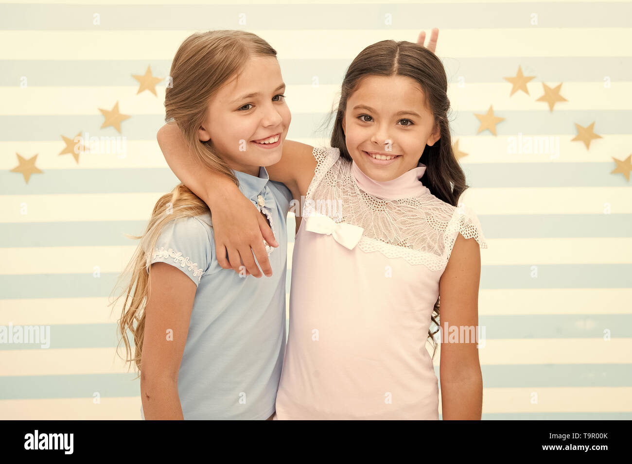 Girls children best friends hugs. Happy childhood concept. Kids schoolgirls preteens happy together. Friendship from childhood. Girls smiling happy fa Stock Photo