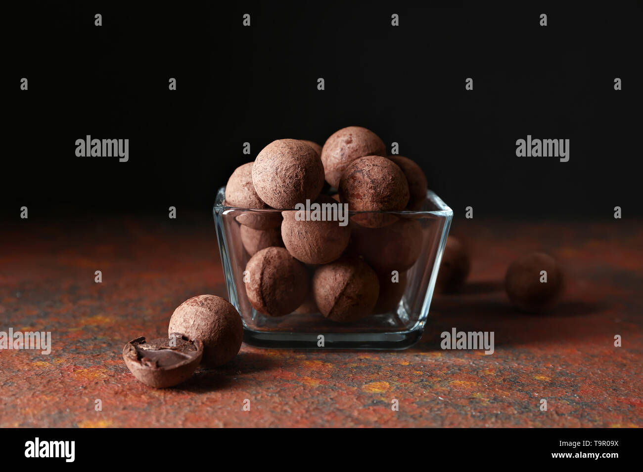 Glass bowl with sweet truffles on color table Stock Photo Alamy