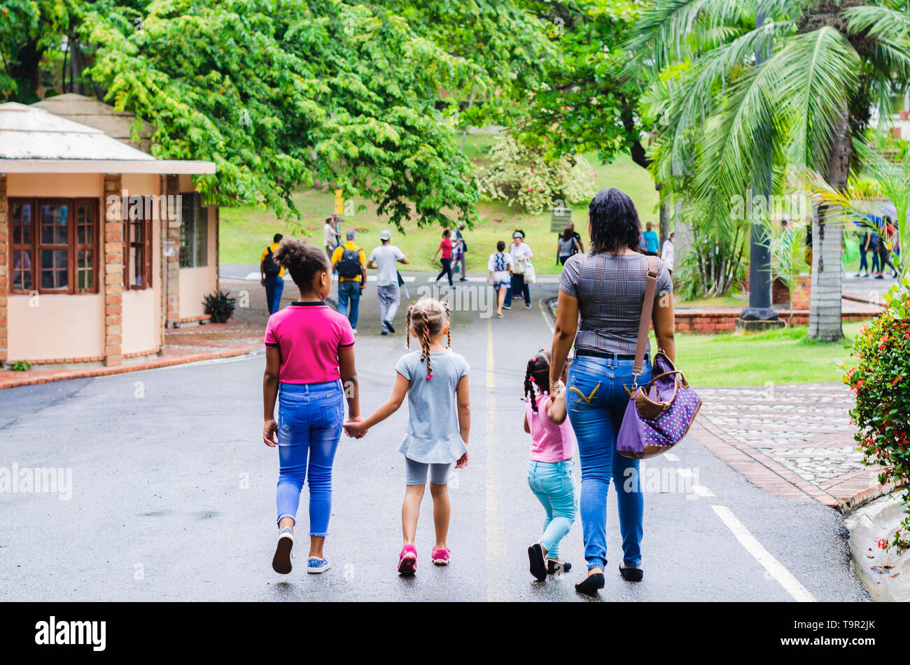 single mother with her daughters modern family, walking in in the park together Stock Photo