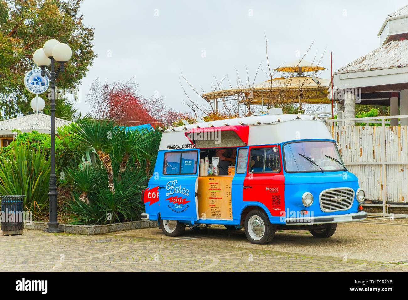 SOCHI,RUSSIA, 18 APRIL 2019-  bright red and blue retro food truck with coffee on wheels on street. Stock Photo