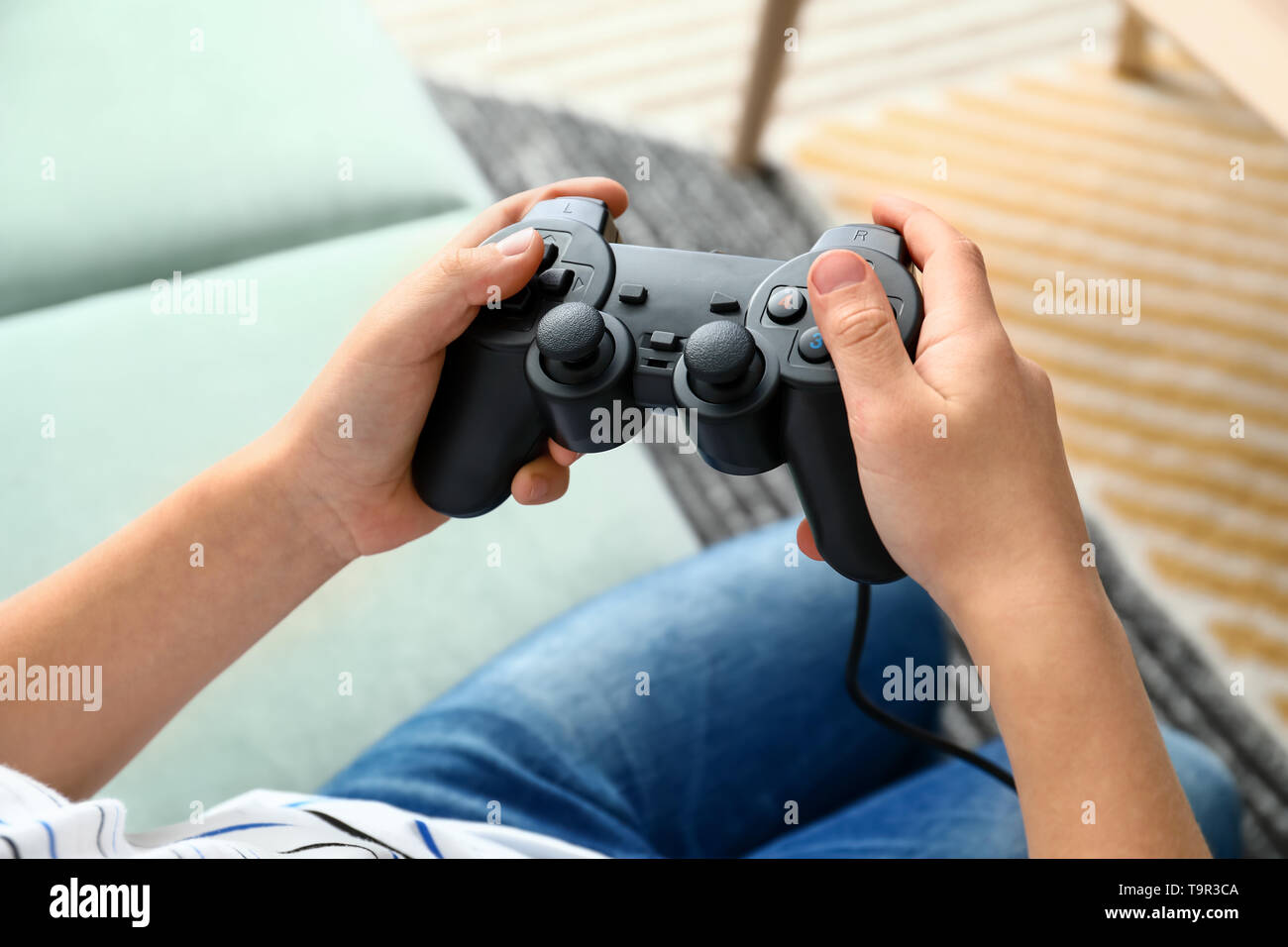 Woman holding a xbox controller and playing popular video game Fortnite on  a television and PC Stock Photo - Alamy