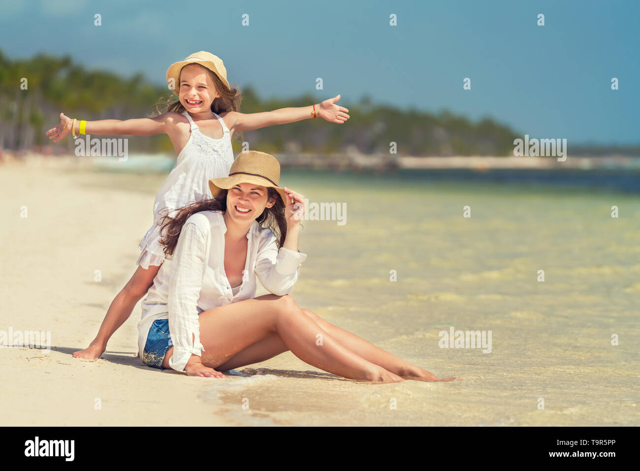 Young mother and little daughter enjoying the beach in Dominican Republic Stock Photo