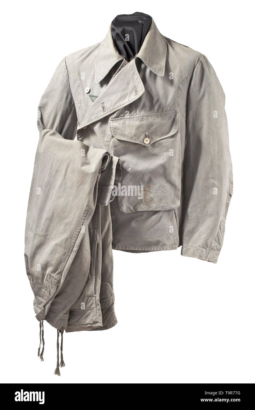 A light special clothing issue outfit of panzer or assault gun units depot piece Unlined tunic of field-grey cotton cloth with light cardboard buttons in special clothing issue cut, however with a slanted double covered fly and left-sided large superimposed front pocket with closure flap, underarm ventilation holes and reinforced side seam openings for a belt. BeVo eagle, silhouettes of collar tabs. The trousers of same material with field-grey cardboard buttons, integrated black web belt and covered fly, both front pockets of unlike size and integrated at different angles,, Editorial-Use-Only Stock Photo