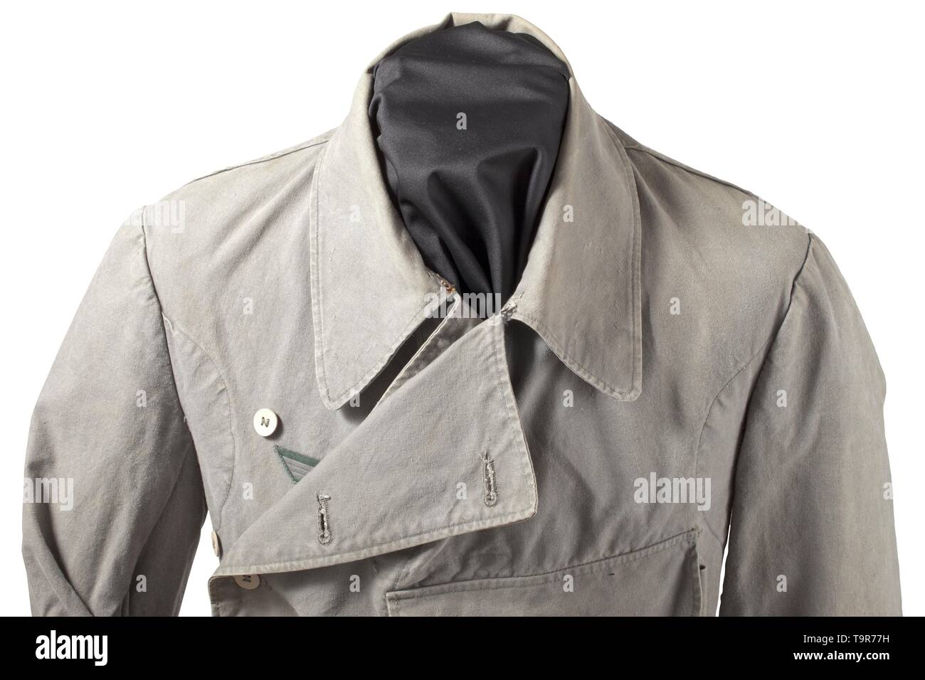 A light special clothing issue outfit of panzer or assault gun units depot piece Unlined tunic of field-grey cotton cloth with light cardboard buttons in special clothing issue cut, however with a slanted double covered fly and left-sided large superimposed front pocket with closure flap, underarm ventilation holes and reinforced side seam openings for a belt. BeVo eagle, silhouettes of collar tabs. The trousers of same material with field-grey cardboard buttons, integrated black web belt and covered fly, both front pockets of unlike size and integrated at different angles,, Editorial-Use-Only Stock Photo