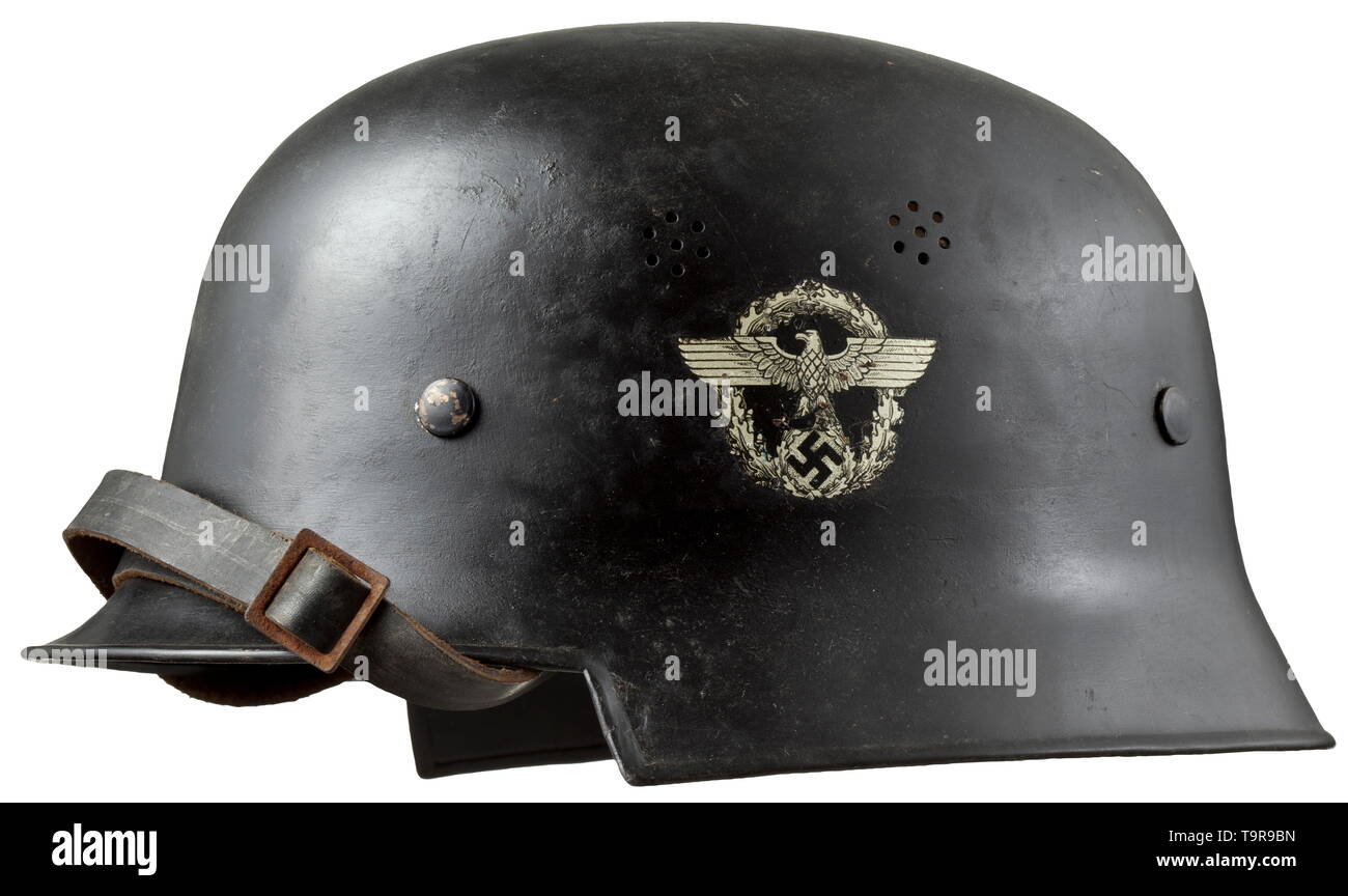 A helmet M 34 for members of the fire protection police/fire brigade The  skull of black-painted sheet iron with both emblems (the national eagle in  early form). Complete with inner liner and