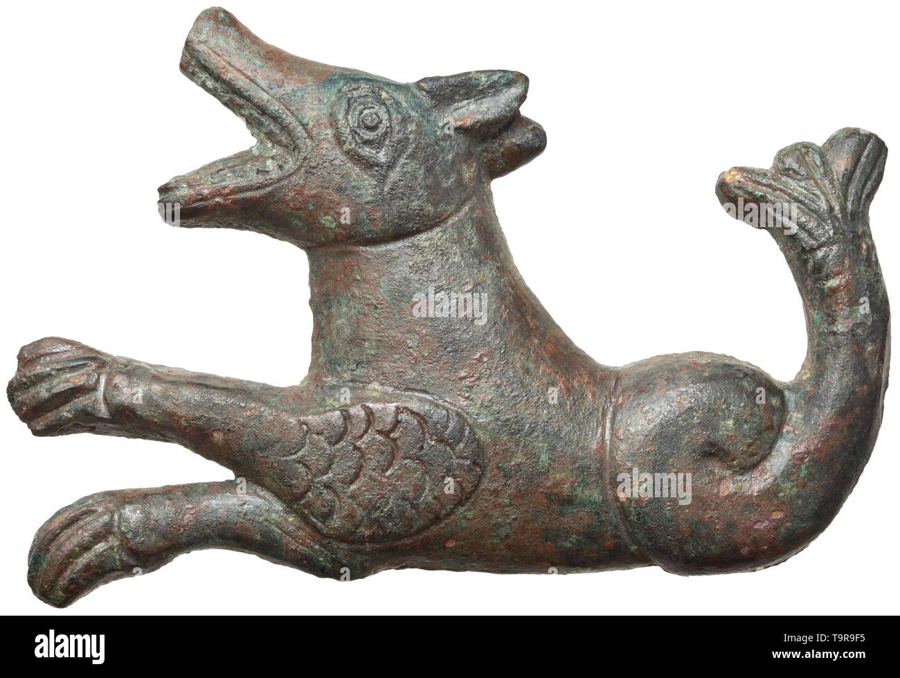 A Roman mount in the form of a mythical water creature, 2nd - 3rd century Solid, bronze mount in high half relief. A mythical creature half canine, half fish. In the open mouth visible fangs, scaled foreleg. Rare portrayal in provincial style. Green patina, length 11 cm. Probably a chariot mount. Provenance: Viennese private collection, acquired in the 1990s from an art dealer. historic, historical, Roman Empire, ancient world, ancient times, ancient world, Additional-Rights-Clearance-Info-Not-Available Stock Photo