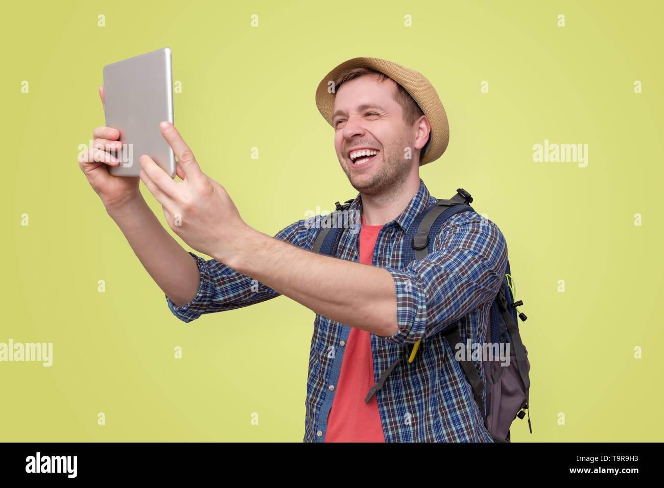 man tourist in summer hat using digital tablet Stock Photo