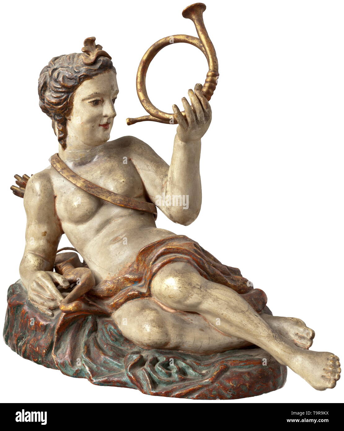 A German wood sculpture of the hunting goddess Diana, 18th century Fully sculptured figure of lime wood with colour painting. Half-reclining Diana with bow and quiver, a hunting horn in her left hand. The oval plinth flattened at back and with opulent arrangement of folds. Paint coat partially slightly dented. Length 39 cm. historic, historical, fine arts, art, 18th century, Additional-Rights-Clearance-Info-Not-Available Stock Photo