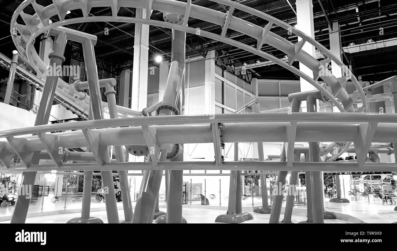 Black and white image of extreme roller coaster with loops in amusement park Stock Photo