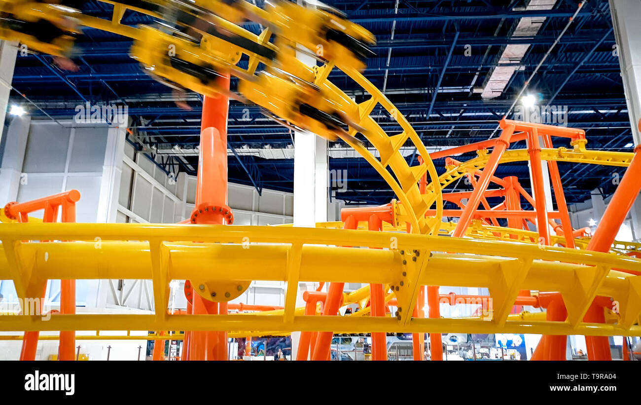 Image of roller coaster with extreme fast loops in big shopping mall Stock Photo