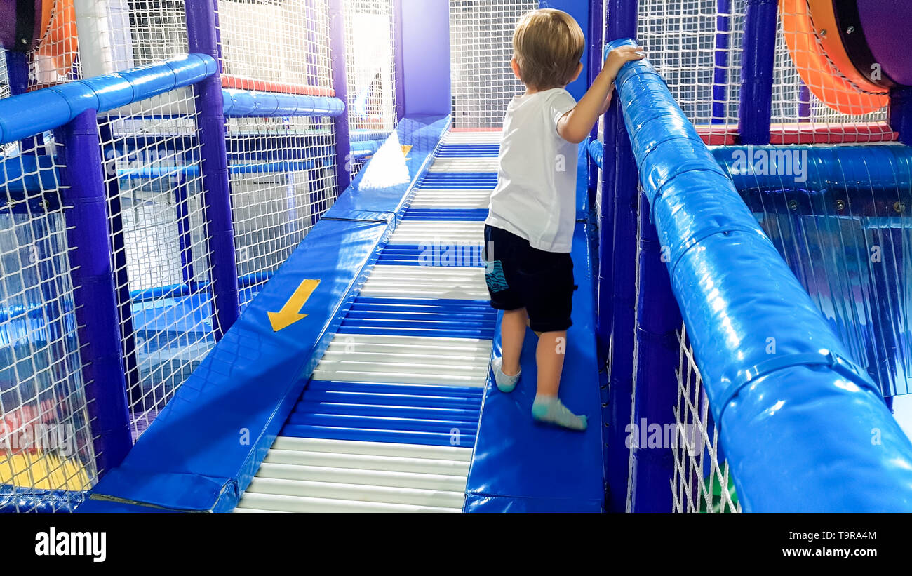 Image Of 3 Years Old Toddler Boy Climbing And Crawling On The