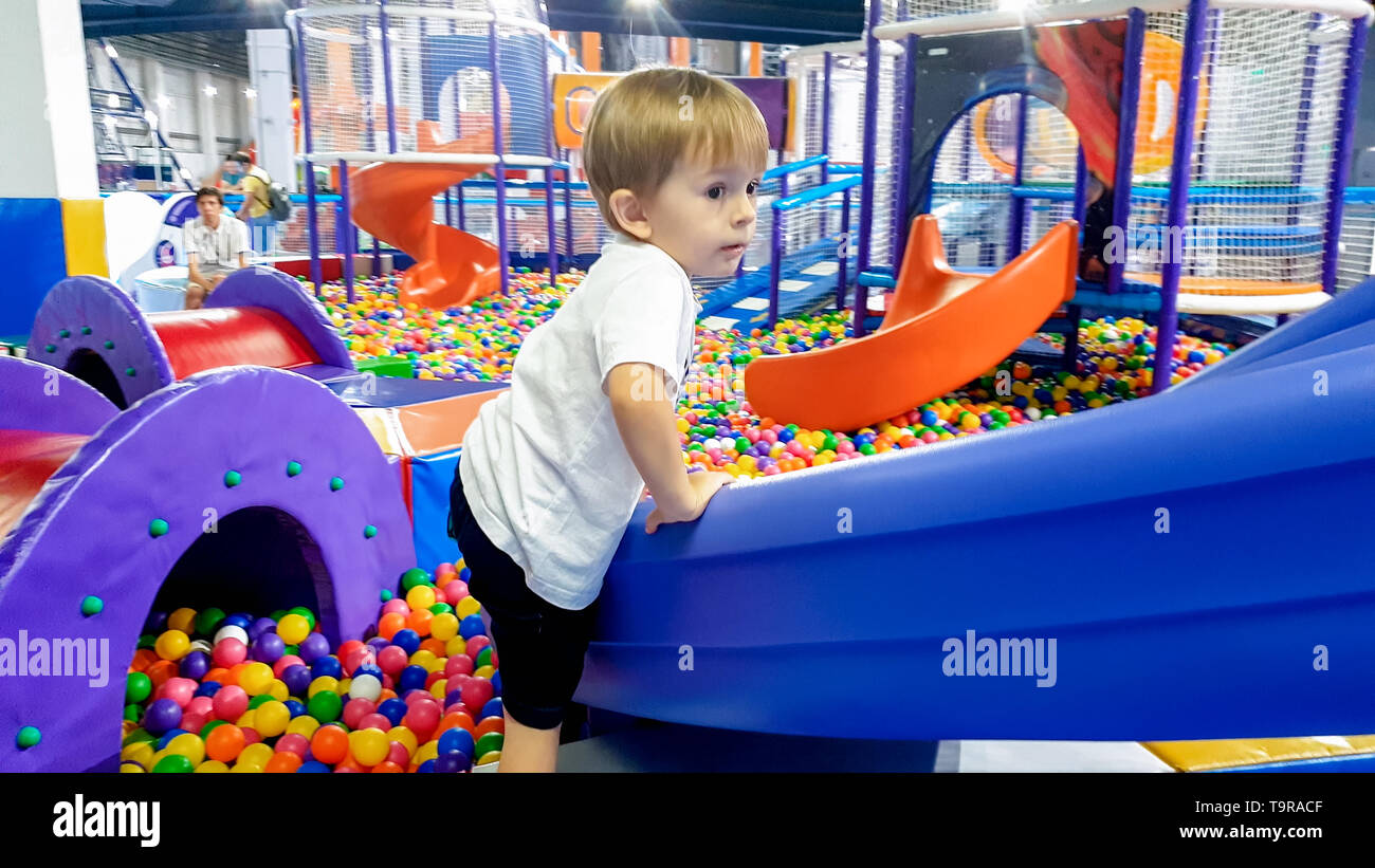 Image Of 3 Years Old Toddler Boy Climbing And Crawling On The