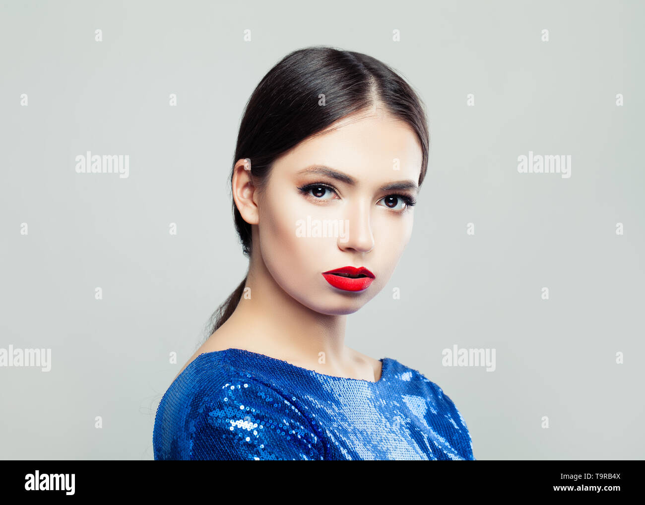 Beautiful brunette woman in blue dress Stock Photo - Alamy
