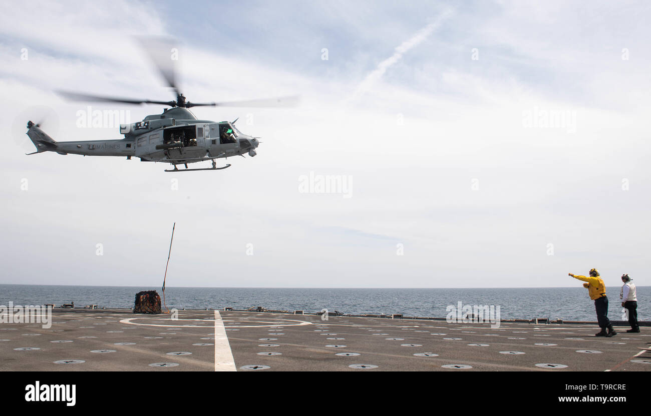 190502-N-HD110-0160  PACIFIC OCEAN (May 2, 2019) Boatswain’s Mate 2nd Class Anthony Zungri, from Bricktownship, N.J., signals to the pilot of a UH-1Y Venom during a vertical replenishment aboard the Harpers Ferry-class amphibious dock landing ship USS Harpers Ferry (LSD 49). Sailors and Marines of the Boxer Amphibious Ready Group (ARG) and the 11th Marine Expeditionary Unit (MEU) are embarked on Harpers Ferry for a regularly-scheduled deployment. (U.S Navy photo by Mass Communication Specialist 3rd Class Danielle A. Baker) Stock Photo