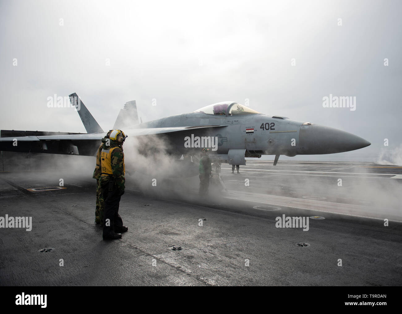 190515-N-GQ458-1018 GULF OF ALASKA (May 15, 2019) Sailors stand by an F/A-18F Super Hornet assigned to the “Golden Warriors” of Strike Fighter Squadron (VFA) 87 before starting flight operations on the flight deck of the aircraft carrier USS Theodore Roosevelt (CVN 71) while participating in Exercise Northern Edge 2019. Northern Edge is one in a series of U.S. Indo-Pacific Command exercises in 2019 that prepares joint forces to respond to crisis in the Indo-Pacific region. (U.S. Navy photo by Mass Communication Specialist 3rd Class Austin J. Breum/Released) Stock Photo