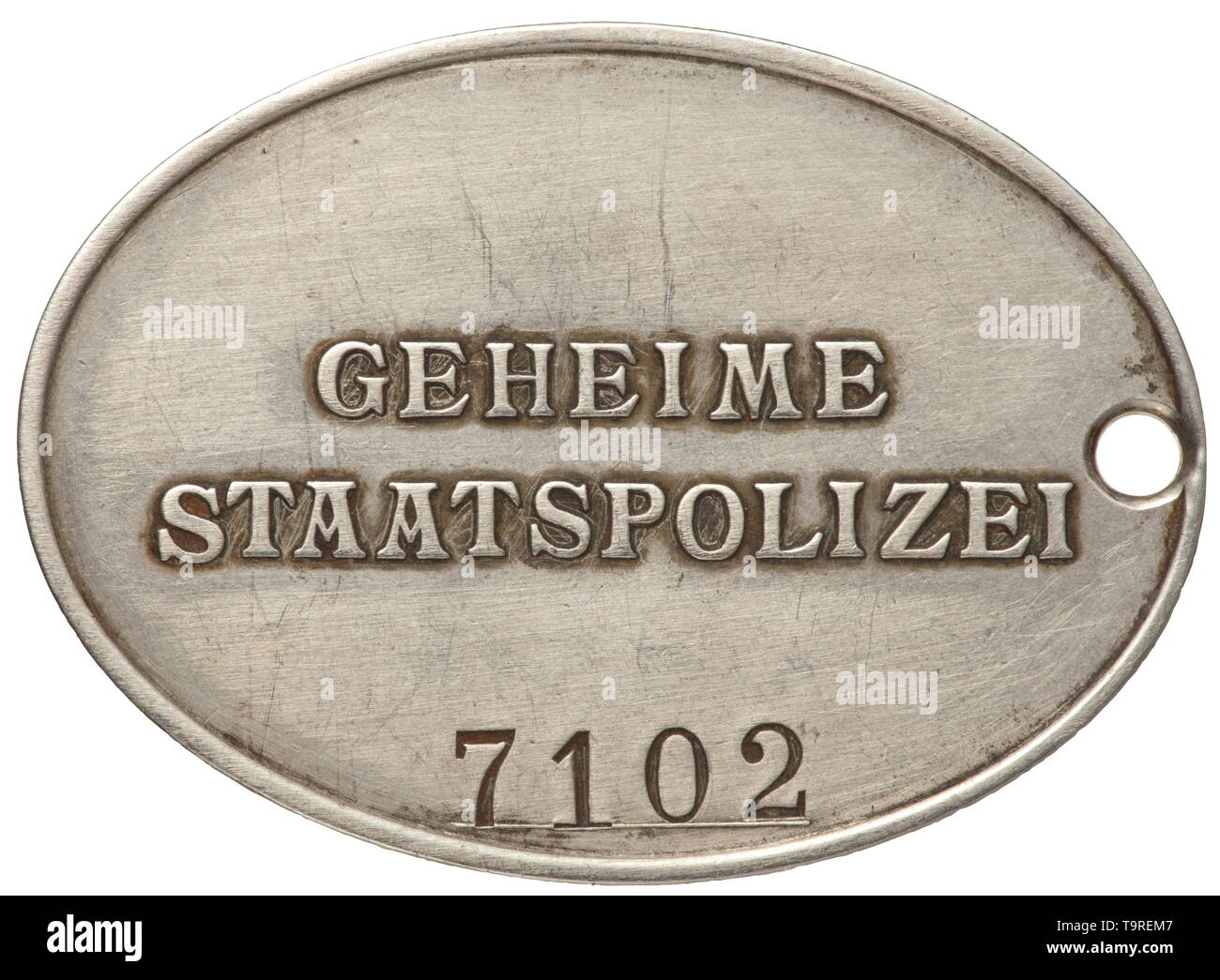 An identification badge '7102' of the GESTAPO Nickel silver. Raised national eagle, the opposite side inscribed in relief 'GEHEIME STAATSPOLIZEI' in typical characters, beneath the struck number '7102'. Dimensions 37 x 51 mm. Very rare. historic, historical, 20th century, Additional-Rights-Clearance-Info-Not-Available Stock Photo