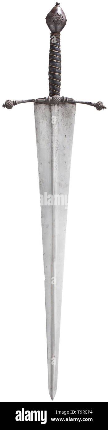 An Italian hand-and-a-half sword, circa 1560 Broad, double-edged, older blade of diamond section, dating from the second half of the 15th century. Ornamental punch marks (rubbed) and smith's mark in the shape of a sword stamped into both sides of the base. Lightly curved iron quillons with stud-shaped spherical finials, guard plate decorated with multiple perforations, thumb ring on the back. Grip covered in leather and wound with brass wire, the double conical pommel finely embossed and chiselled with four continuous floral ornaments in relief. , Additional-Rights-Clearance-Info-Not-Available Stock Photo