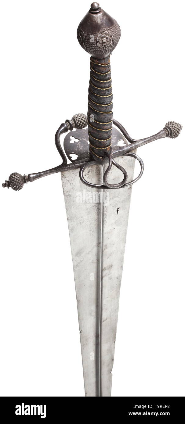 An Italian hand-and-a-half sword, circa 1560 Broad, double-edged, older blade of diamond section, dating from the second half of the 15th century. Ornamental punch marks (rubbed) and smith's mark in the shape of a sword stamped into both sides of the base. Lightly curved iron quillons with stud-shaped spherical finials, guard plate decorated with multiple perforations, thumb ring on the back. Grip covered in leather and wound with brass wire, the double conical pommel finely embossed and chiselled with four continuous floral ornaments in relief. , Additional-Rights-Clearance-Info-Not-Available Stock Photo