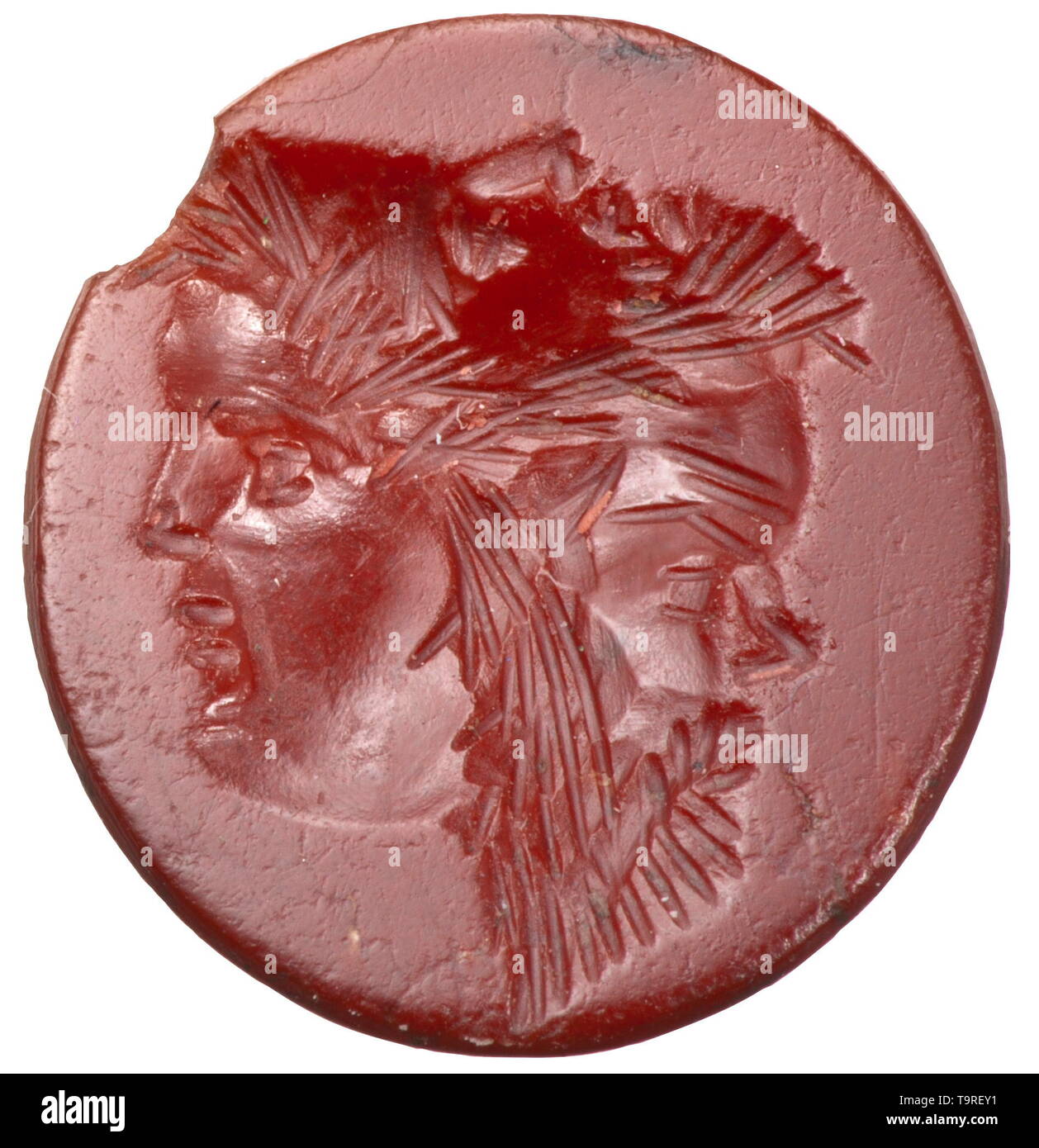A Hellenistic Carnelian intaglio with gryllos in a Roman silver ring, 1st century and 3rd century Very finely crafted intaglio dating from the late Hellenistic period with an optical illusion of three heads which appear to change depending on the viewer's perspective (gryllos): a young woman, a bearded man and a satyr. Excellent portraits. Set in a silver ring dating from the 3rd century, the intaglio loose today. Intaglio 1.5 x 1.4 cm. Minimal chipping at the edge, the overall image not affected thereby. Maximal diameter of the ring 2.3 cm. Prov, Additional-Rights-Clearance-Info-Not-Available Stock Photo