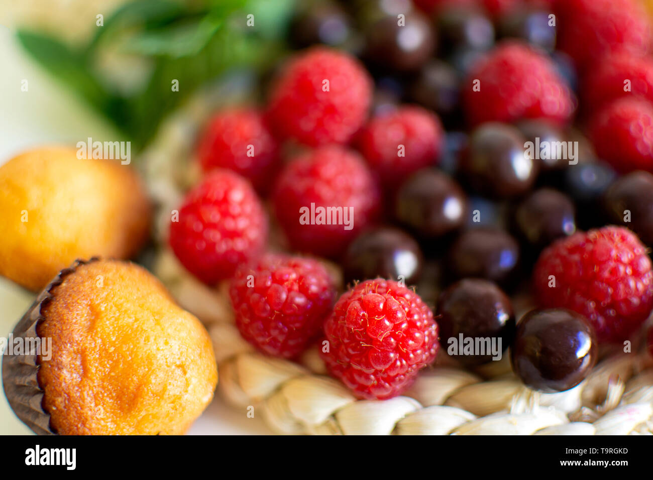 Breakfast background with muffins and blackberries and red berries. Start the day with energy. Eat when getting up Stock Photo