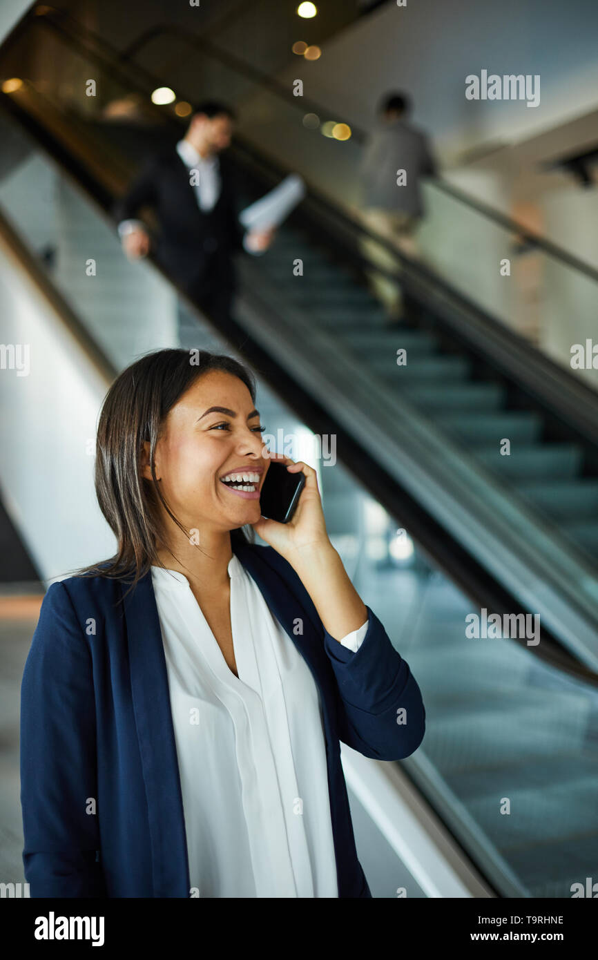 Excited black woman laughing while talking on phone Stock Photo - Alamy
