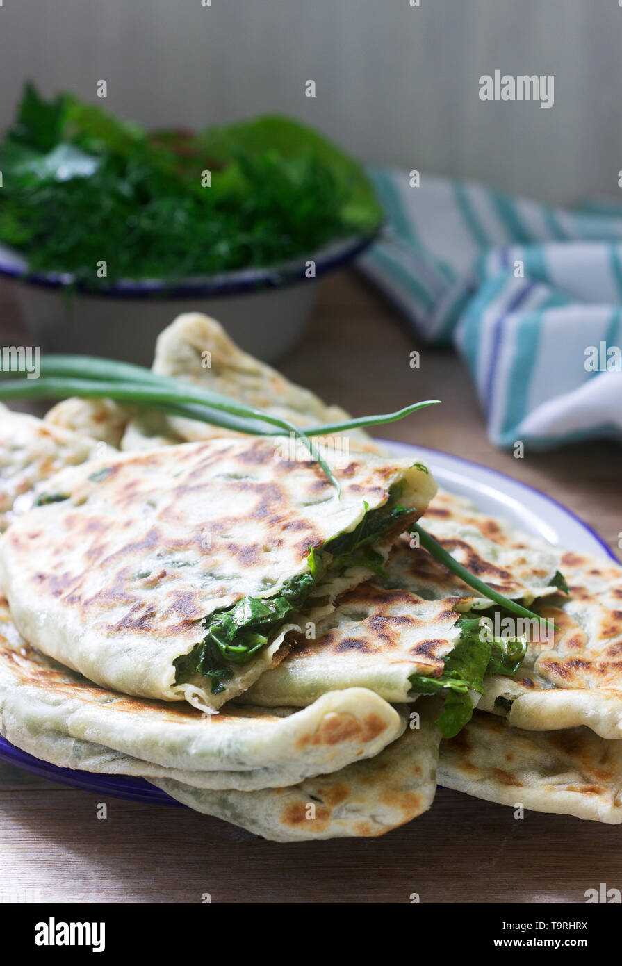 Baker making traditional dish of Armenians from Artsakh Zhingyalov hats is  a type of flatbread stuffed with finely diced herbs and green vegetables. S  Stock Photo - Alamy