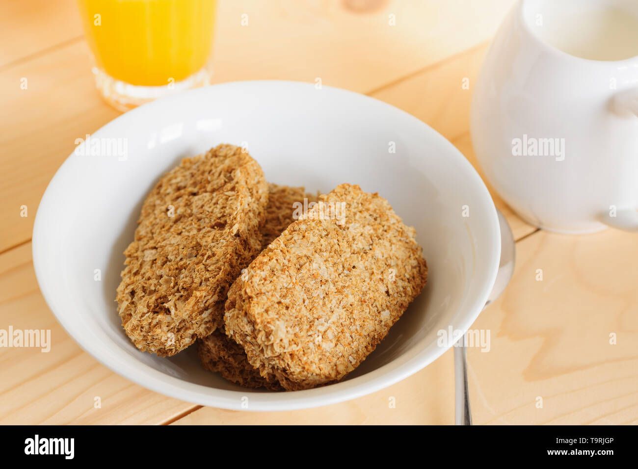 Healthy whole wheat breakfast cereal biscuits with orange juice Stock