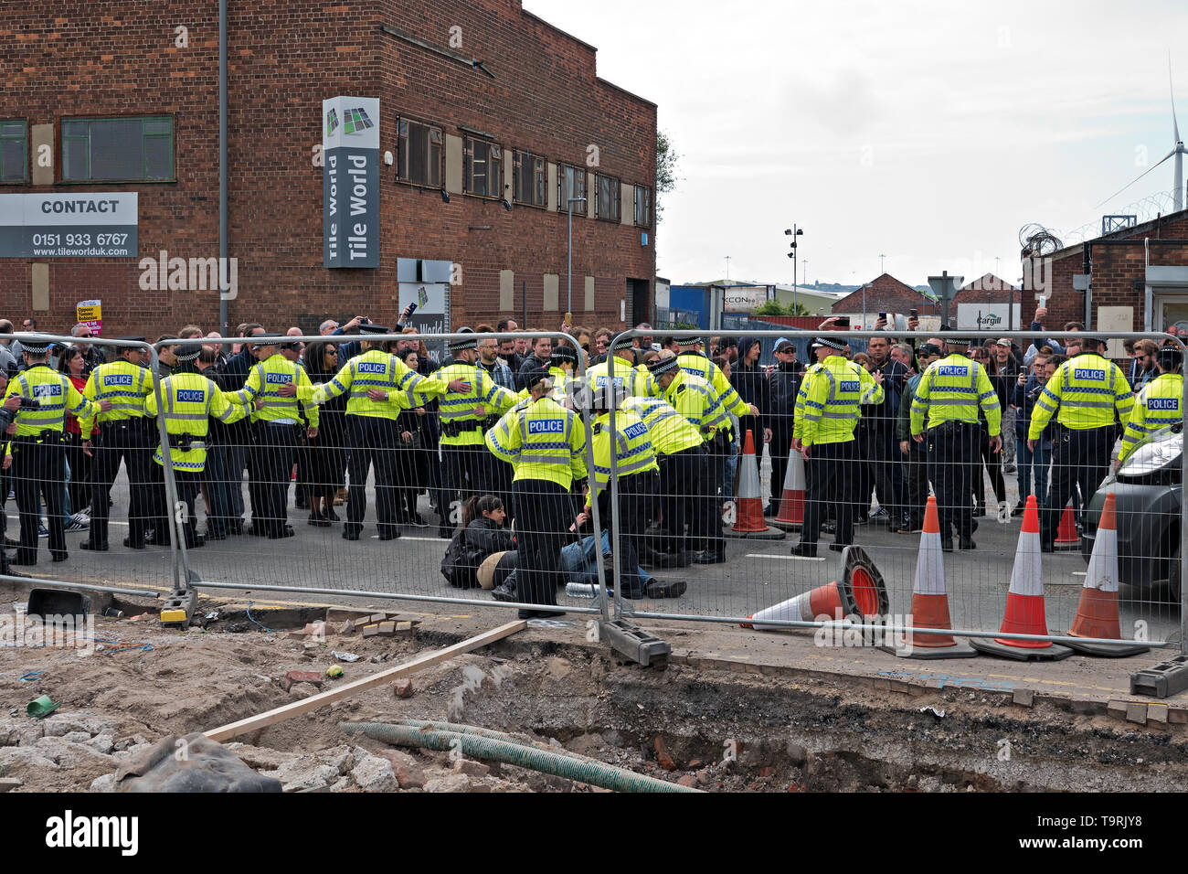 Police controlling a crowd of anti Tommy Robinson demonstrators as he campaigns in Bootle Liverpool UK for the Euro MEP elections. Stock Photo