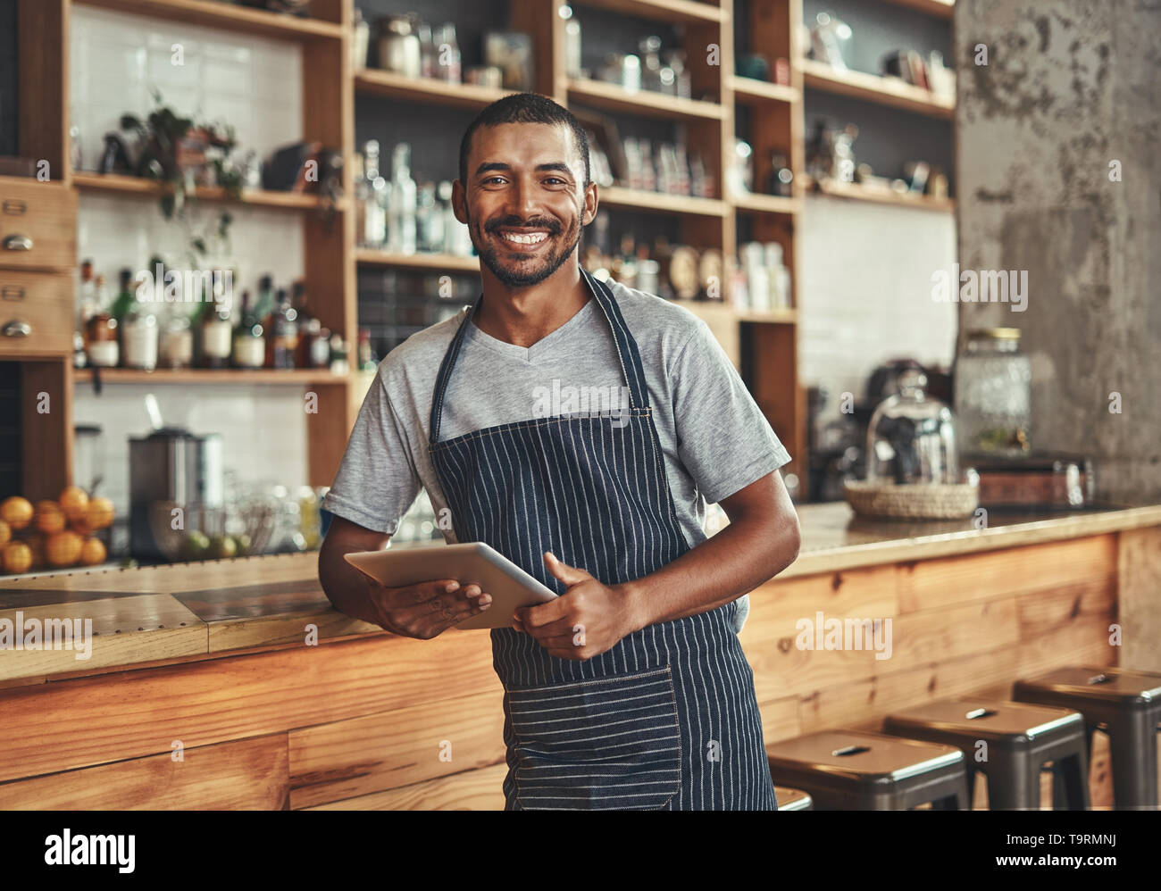 Portrait of a smiling young african cafe owner Stock Photo
