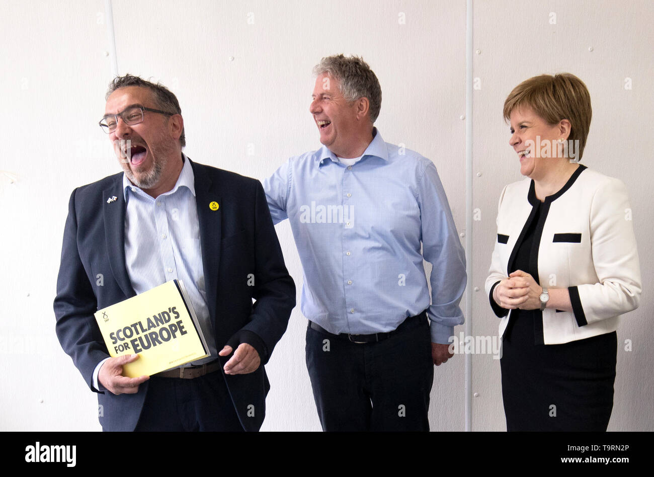 First Minister Nicola Sturgeon with SNP European election candidate Christian Allard (left) and owner Andrew Charles during a visit to J Charles Ltd seafood processing plant in Aberdeen. Christian Allard worked at J Charles Ltd for 25 years exporting seafood to the continent, before he entered politics. Stock Photo