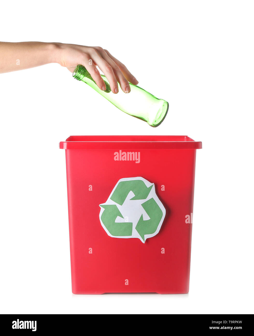 Female hand throwing garbage into trash bin on white background