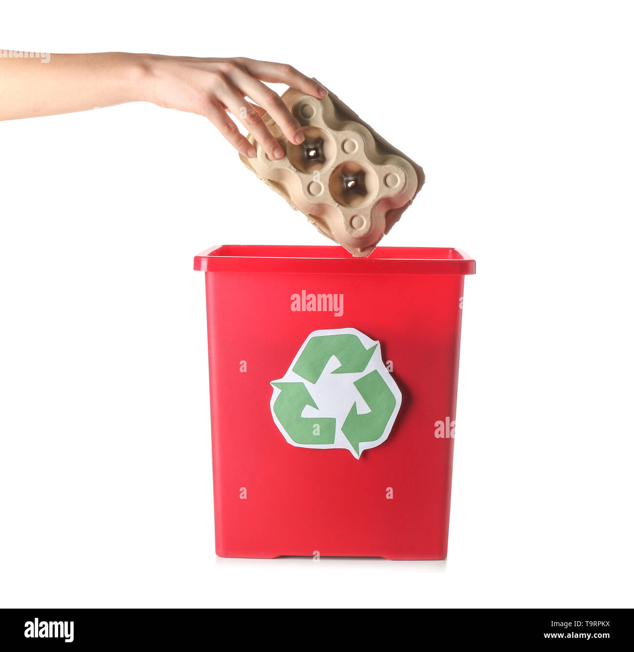 Female hand throwing garbage into trash bin on white background