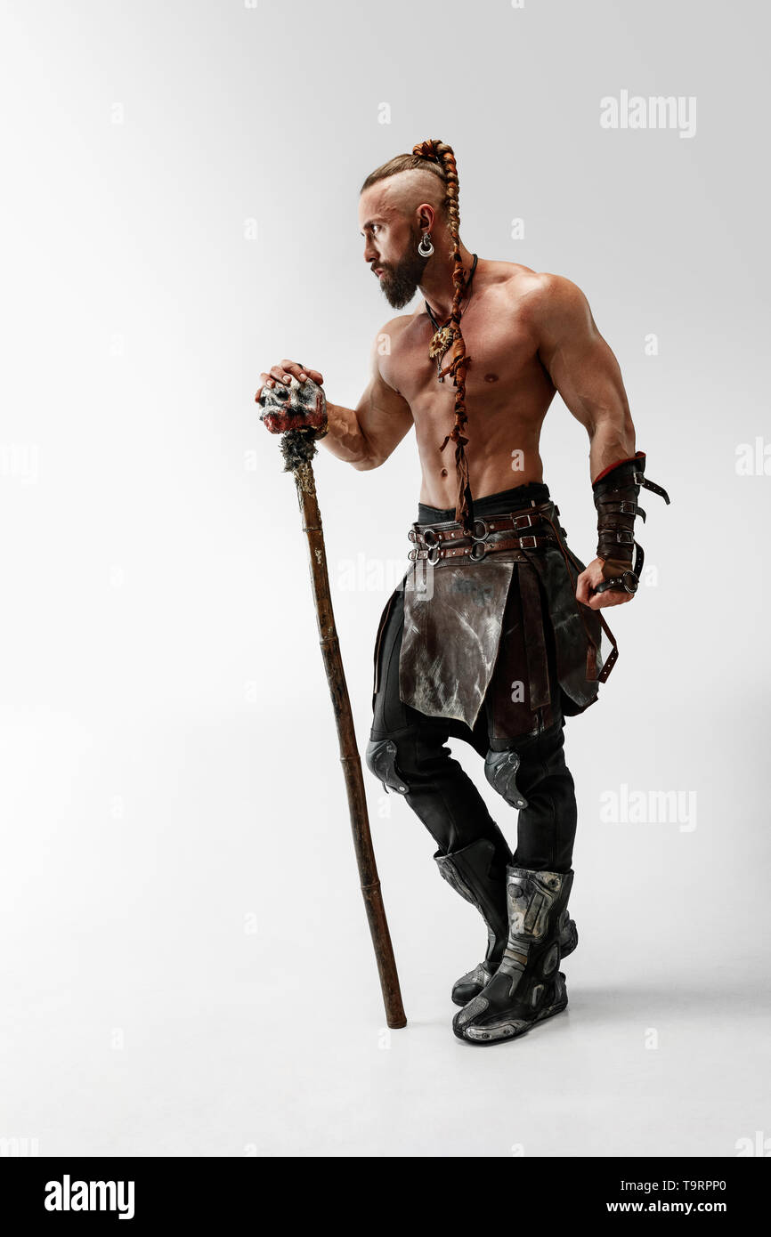 Serious long hair and muscular male model in leather viking's costume with  the big mace cosplaying isolated on white studio background. Full-length  portrait. Fantasy warrior, antique battle concept Stock Photo - Alamy