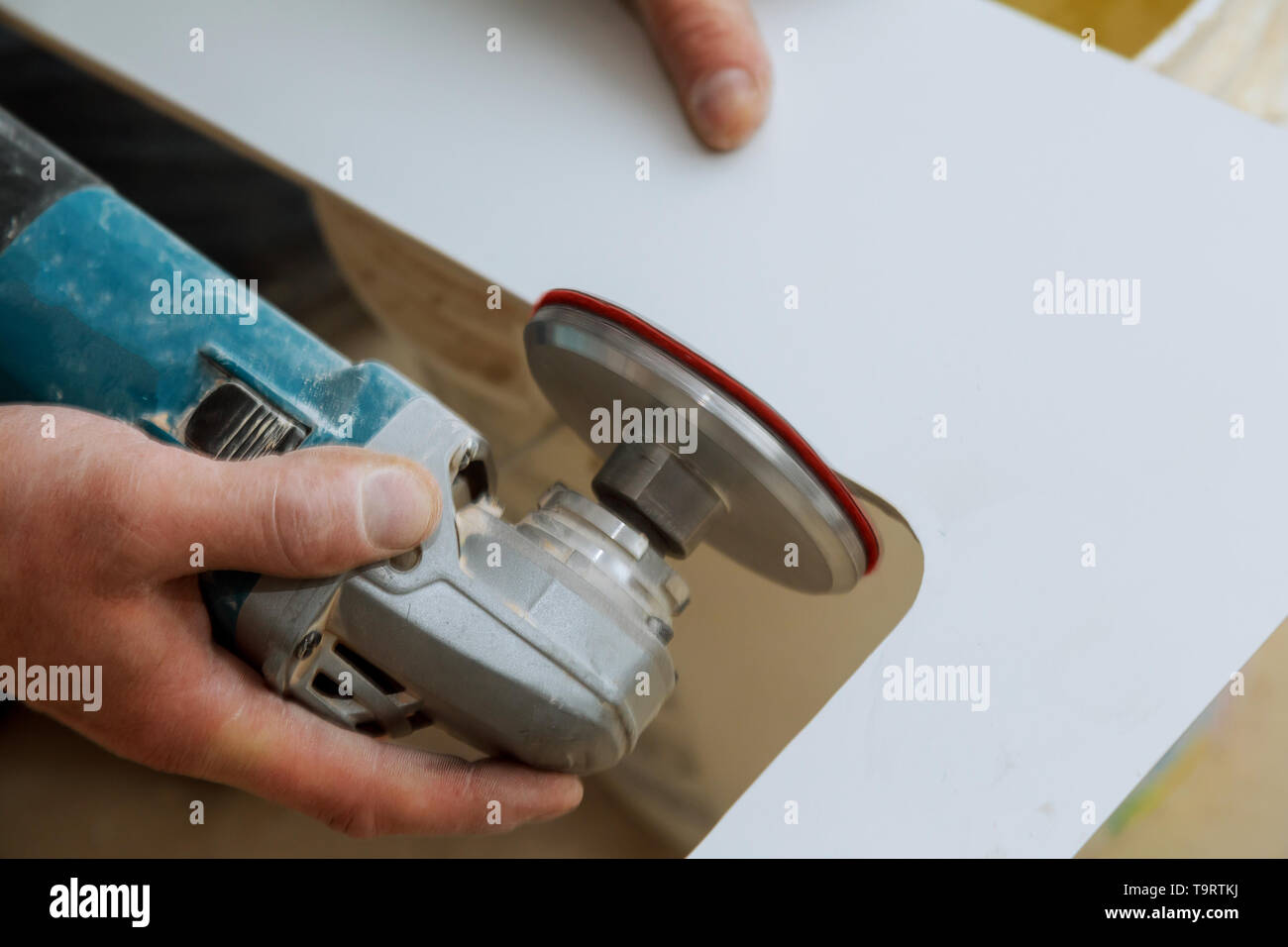 Man worker cutting beige tile with a circular saw on a cutting flooring