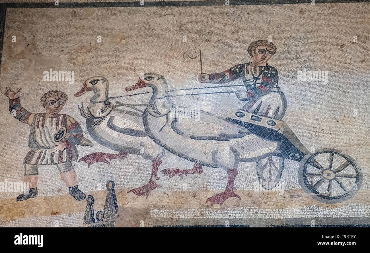 Children's chariot race one of the Roman mosaics in the Villa Romana del Casale, Piazza Armerina, Sicily, Italy. Stock Photo