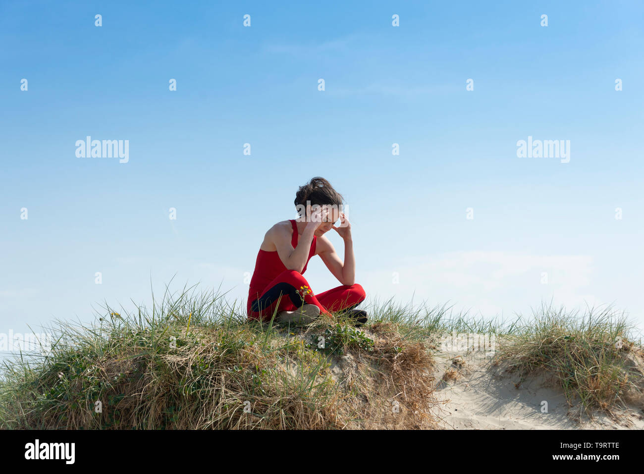 woman athete sitting psyching herself up before a competition. Stock Photo