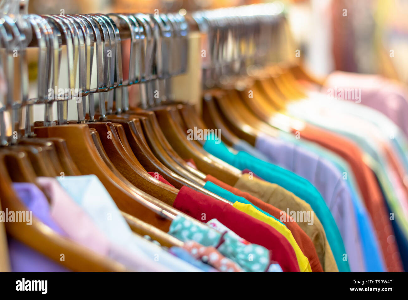 Second Hand Clothing on Hanger at the street bazaar Close up Stock Photo