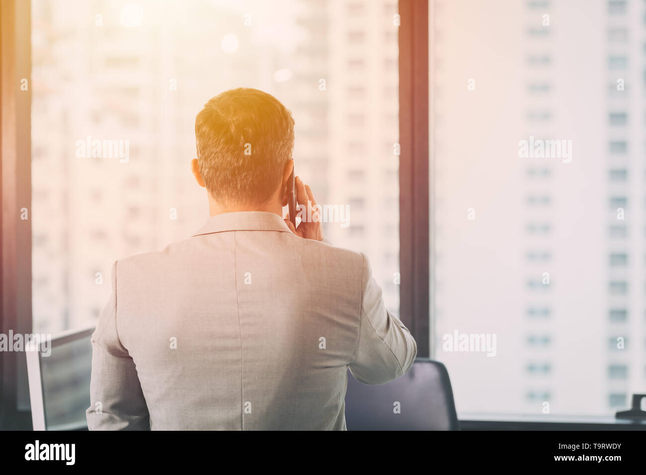 Man looking out of window - Stock Image - F009/8001 - Science