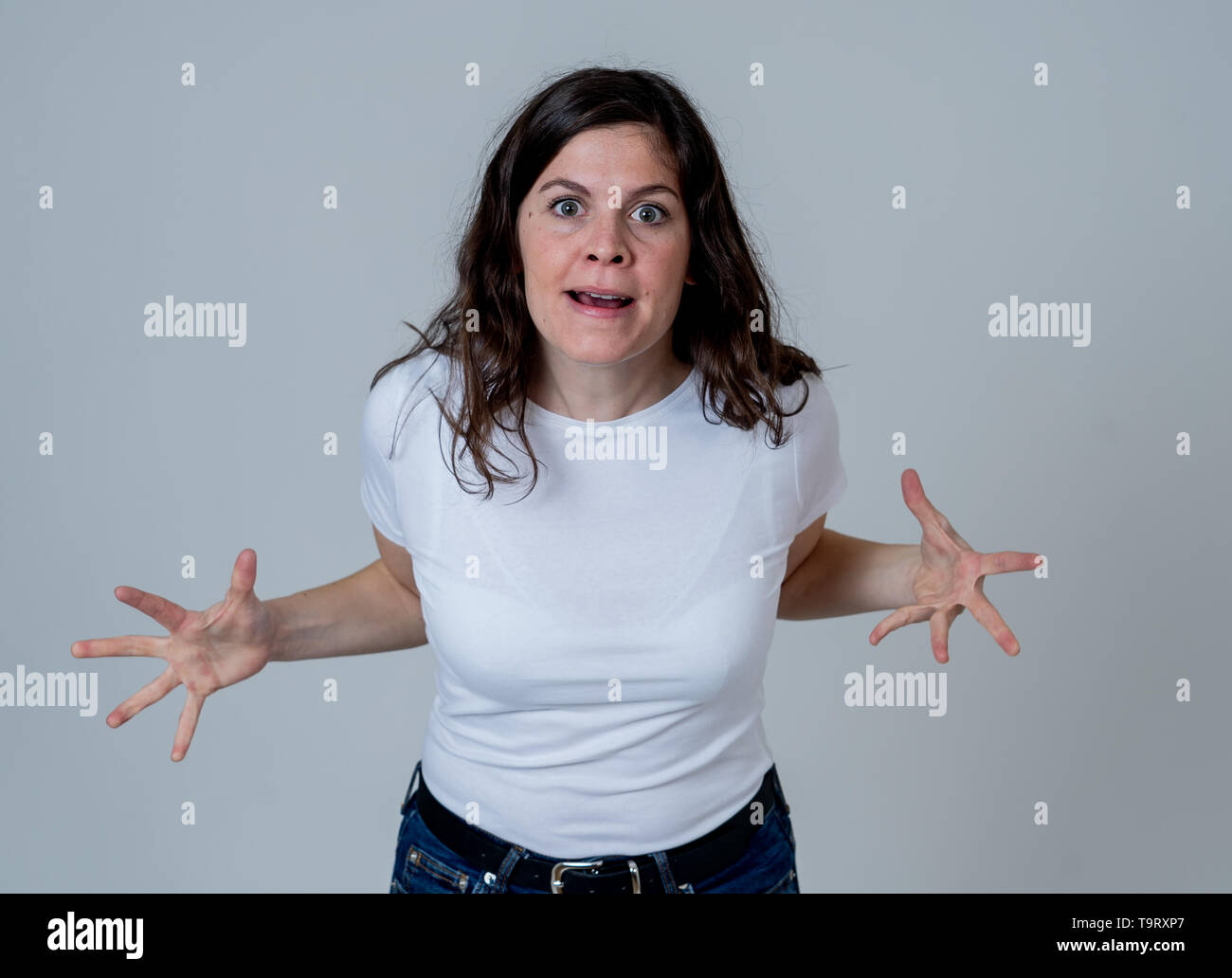 Facial expressions and emotions. Portrait of Young attractive caucasian woman with an angry face. Looking mad and crazy shouting and making furious ge Stock Photo