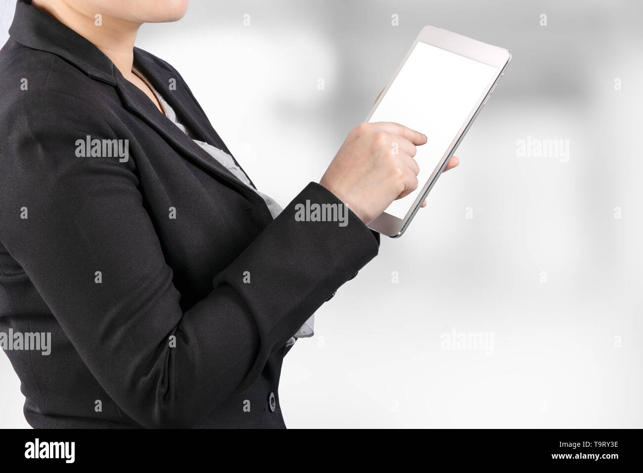 close up of a business woman working on tablet with clipping path on white screen for easy replace you design on tablet screen Stock Photo