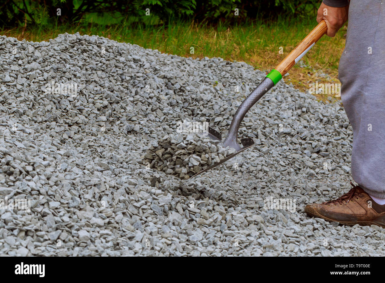 Spreading gravel manually with dirty shovel working Stock Photo Alamy